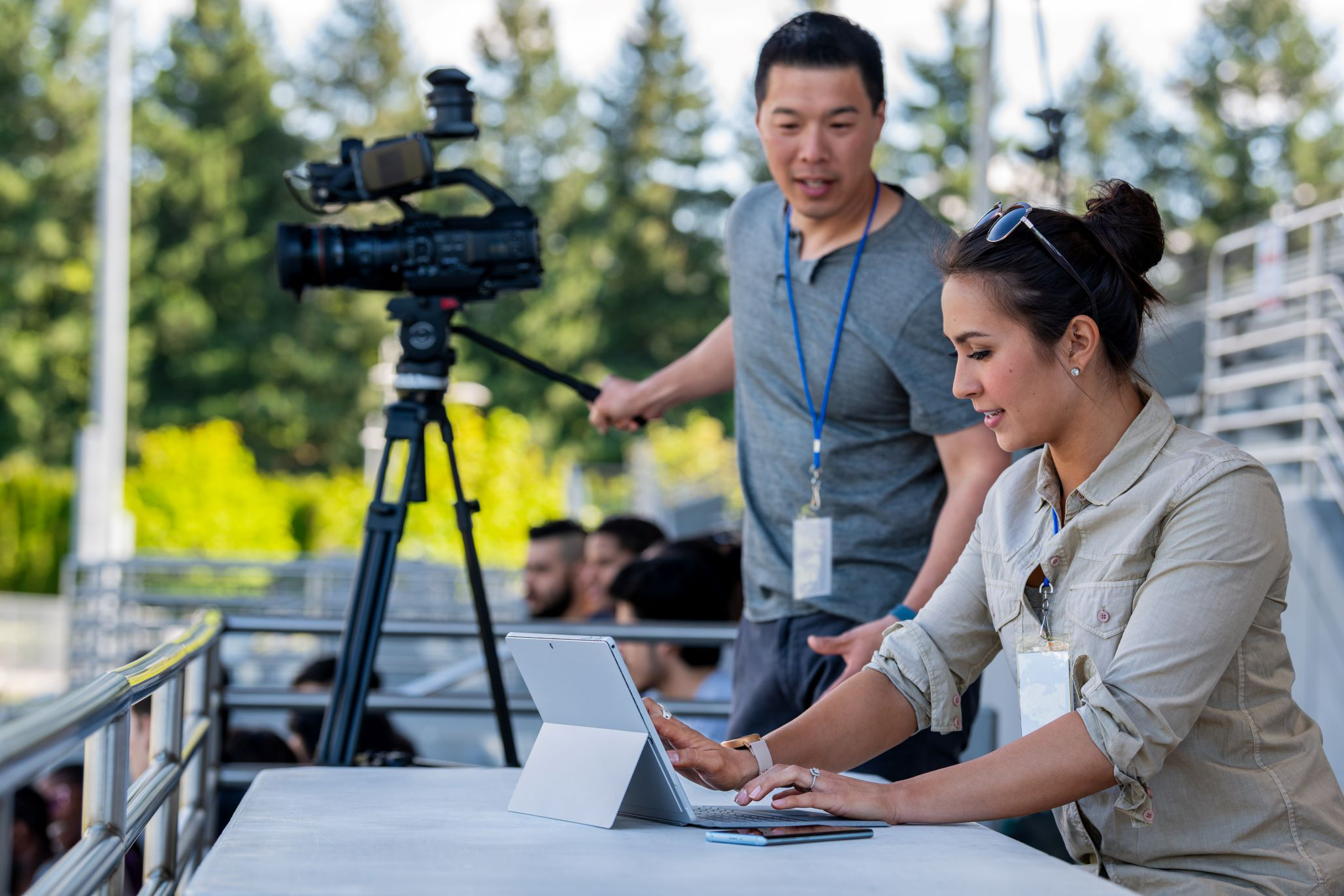 A woman using a tablet to create and edit video with efficient generative AI.