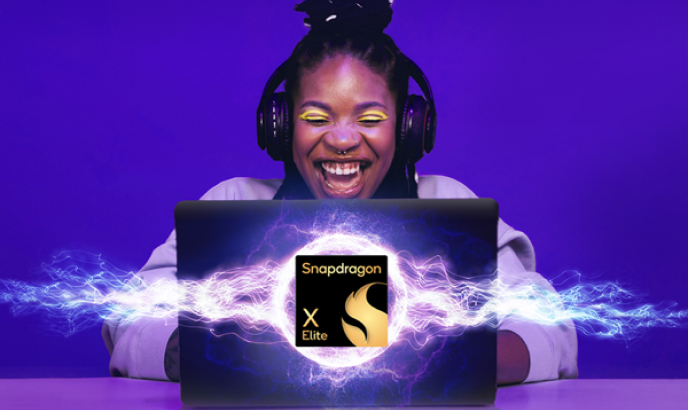 The Snapdragon X Elite compute processor is centered in the image, on the front of a laptop. Behind the laptop sits a Black woman with braids worn up. She is wearing headphones and bright yellow eyeliner.