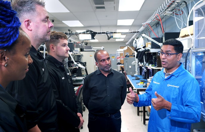 Lucy Hedges, Paul Smith and Kevin Breeze (left) listen to Sanjeev Kumar (right) while Senthil Kishnasamy looks on (center).