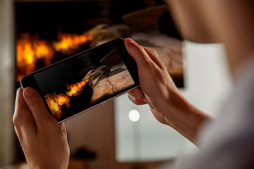 Person on smartphone using Wi-Fi to game.