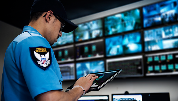 Security guard using tablet as form of surveillance 