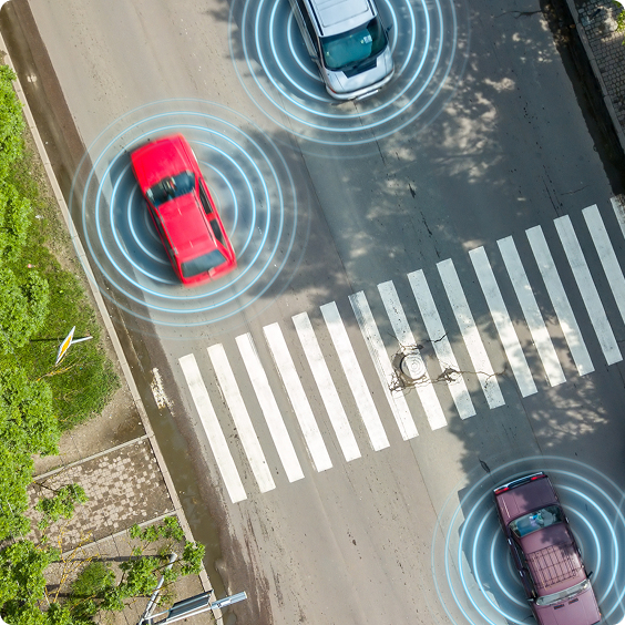 Aerial view of cars with connectivity sensor rings near a pedestrian crossing