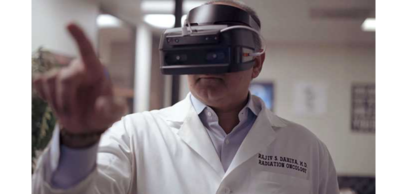 Radiation oncologist using the Qualcomm Snapdragon 835 VR development kit to interact with the Think FAST training simulation.