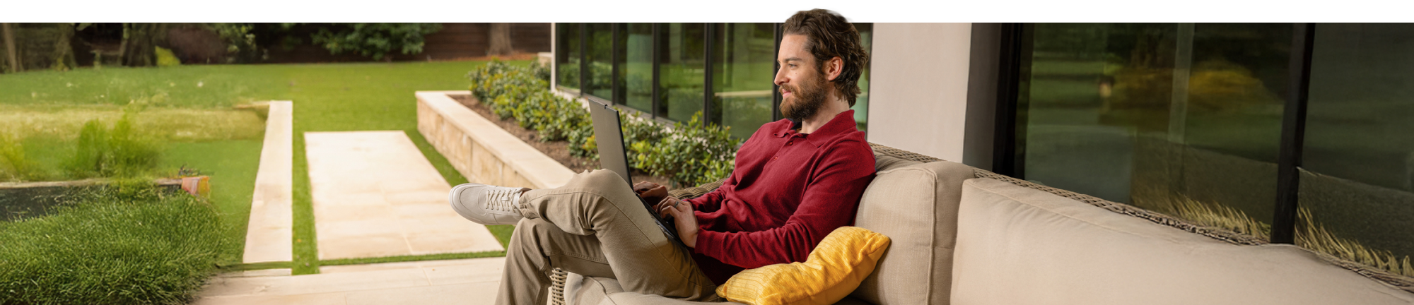 Man works comfortably on a laptop outdoors.