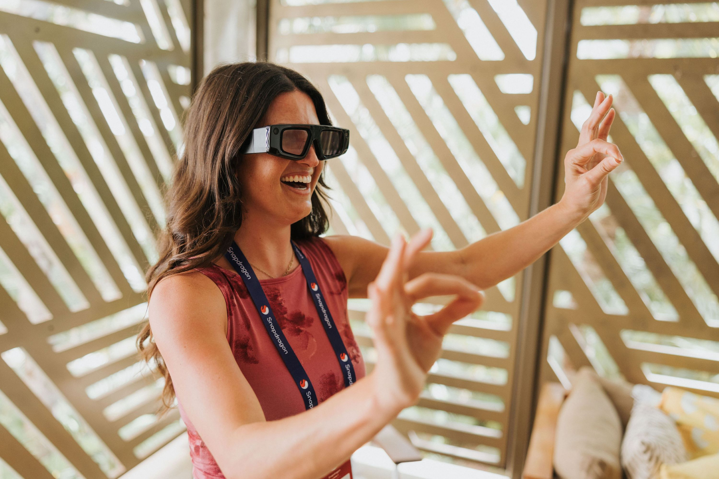 A woman using AR glasses at Snapdragon Summit 2024. Beyond the keynotes, Snapdragon Summit 2024 featured a variety of demos in which attendees experienced the latest Snapdragon-powered innovations across mobile, compute and XR.