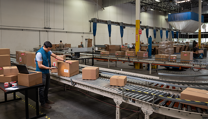 Person using a smart tool to scan inventory at a factory