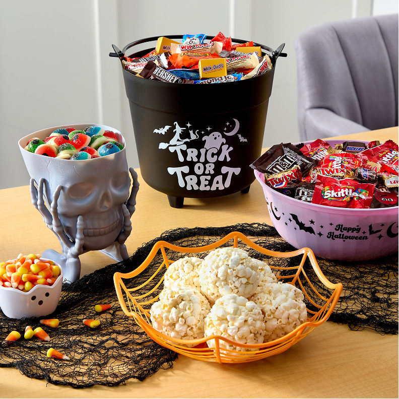 Halloween treats and candy display featuring popcorn, candy corn, and assorted sweets
