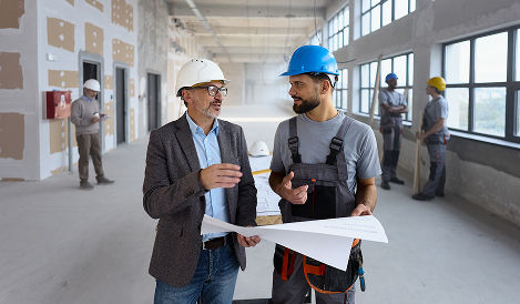 Two construction workers talking