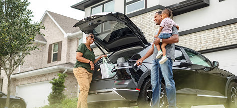 Family packing a car for a road trip