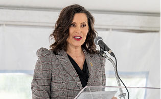 Michigan Governor Gretchen Whitmer speaking at a podium