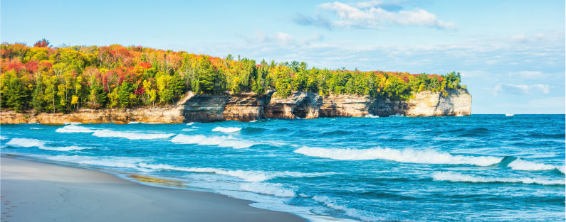 Lake Superior shorline with autumn strees atop pictured rocks