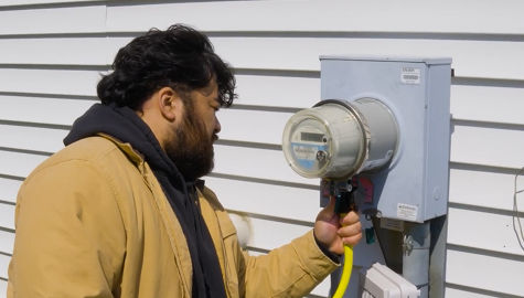 Man plugging generator into the Surge Protection Plus meter on a home