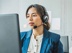 Woman working in a call center wearing headphones.