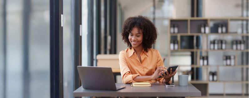 Woman working on her laptop in a place of business