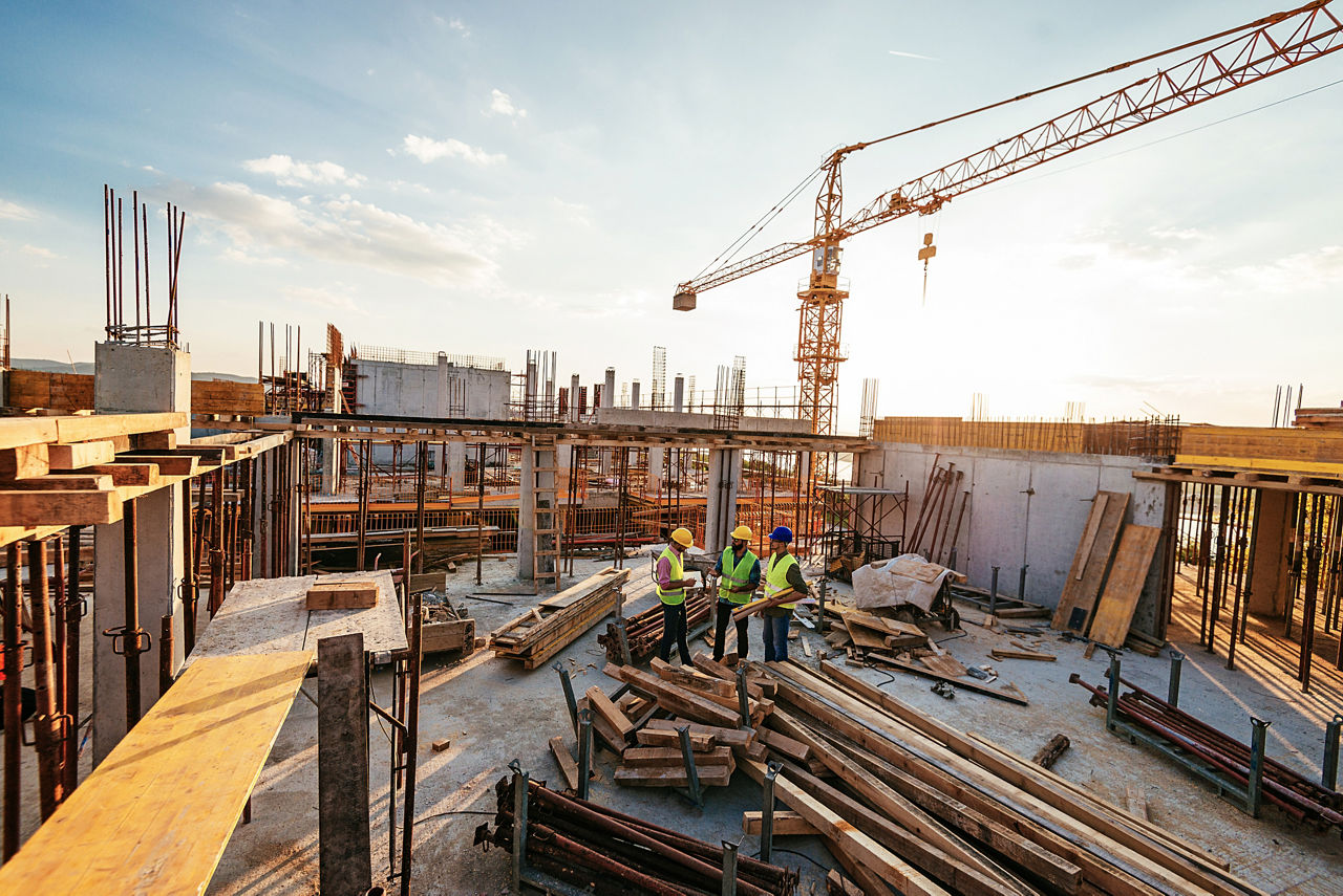 two men discussing energy efficient equipment for a large high-rise construction site