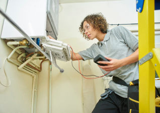 Female checking HVAC equipment for energy efficiency