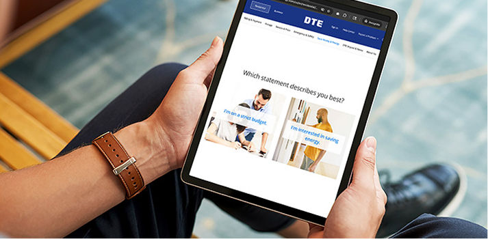 Closeup of man holding a tablet with the DTE energy assessment on the screen.