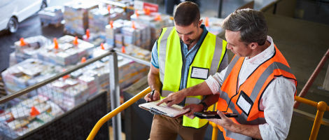 two men discussing on a loading dock