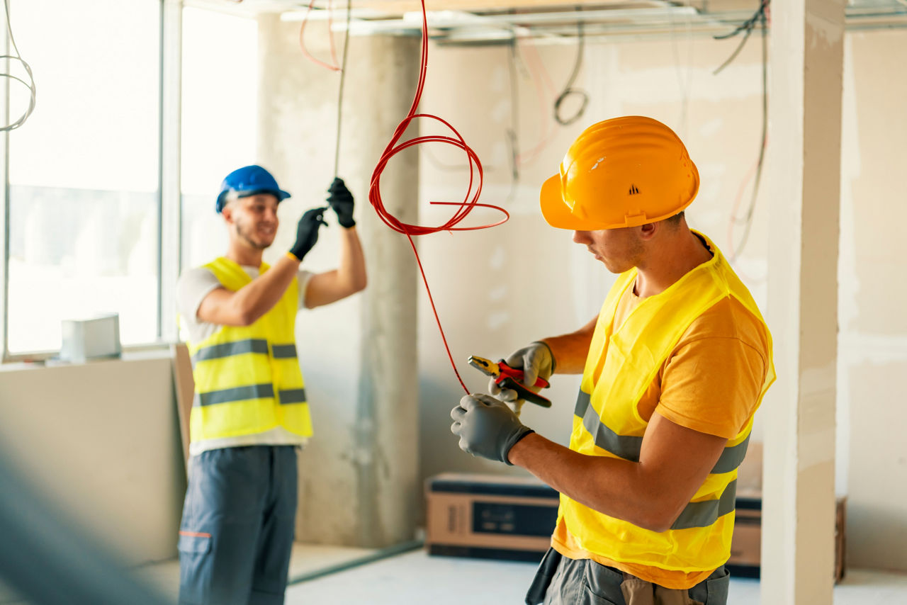 two DTE electricians working on a new construction 