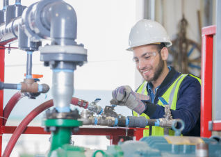 technician working on fitting pipes