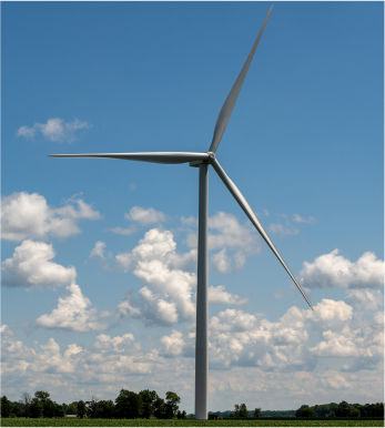 Wind turbine with a cloudy sky background