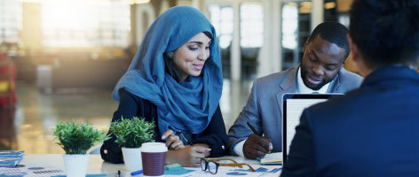 woman sitting at a table talking with colleagues