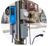 Pole-mounted EV charger on utility pole.