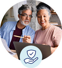 Couple reviewing documents with a shield icon symbolizing security.