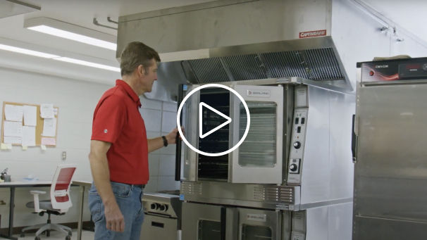 Man closing door of an industrial oven