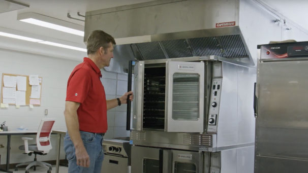 Man closing door of an industrial oven