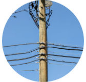Closeup of telecommunications equipment on utility pole.
