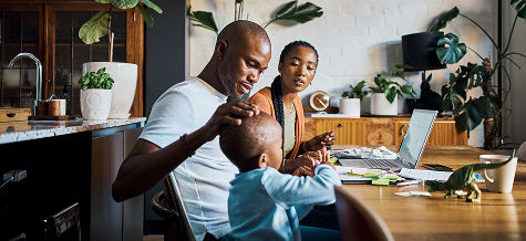 Family at table looking at laptop