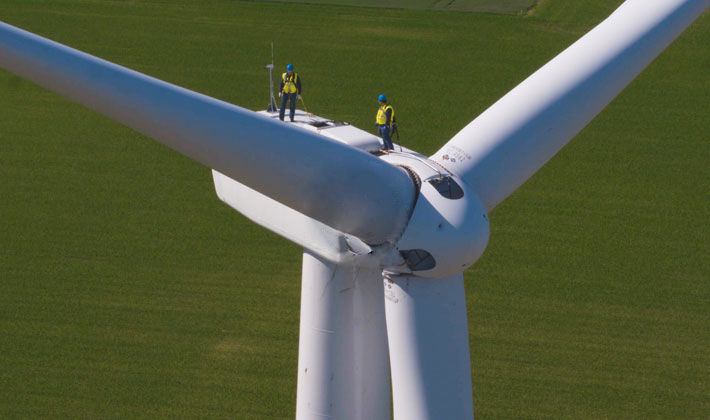Areal view of DTE employees on top of a wind turbine