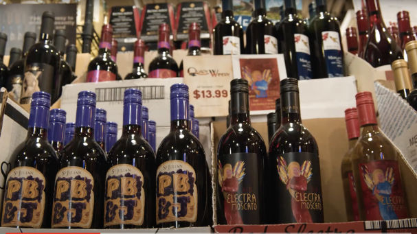 red wine on a shelf at the Wine Palace store