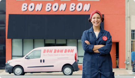 Woman smiling at the camera in front of Bon Bon Bon store