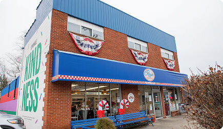 Brick building with a blue awning for Ray's Ice Cream