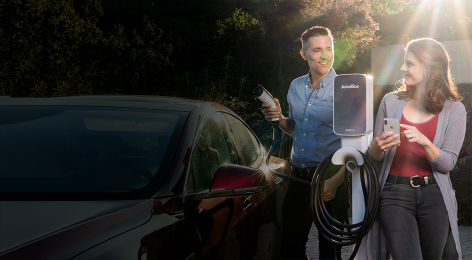 Couple charging electric vehicle