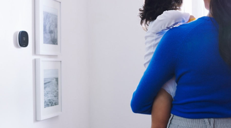 Woman holding toddler in bedroom