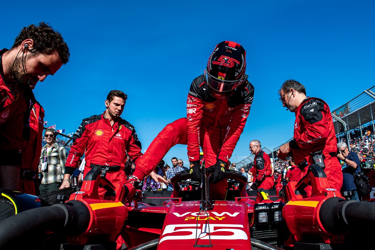 Ferrari racer climbing into racecar surrounded by cockpit crew, Asset Management | DXC Technology Insights