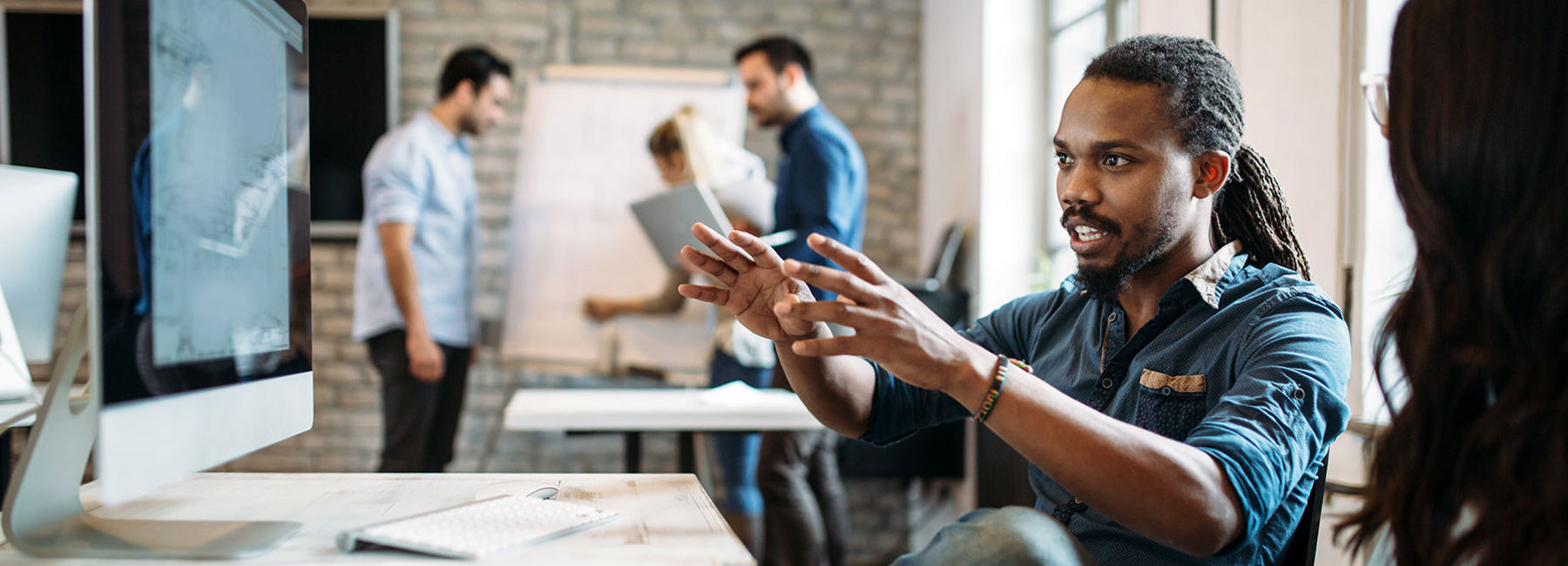 man gesturing at computer screen with intent and energy | DXC Technology Insights