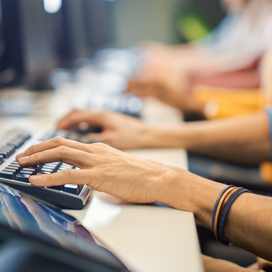 Row of People Works on PCs, Cloud & Infrastructure | DXC Technology Customer Story