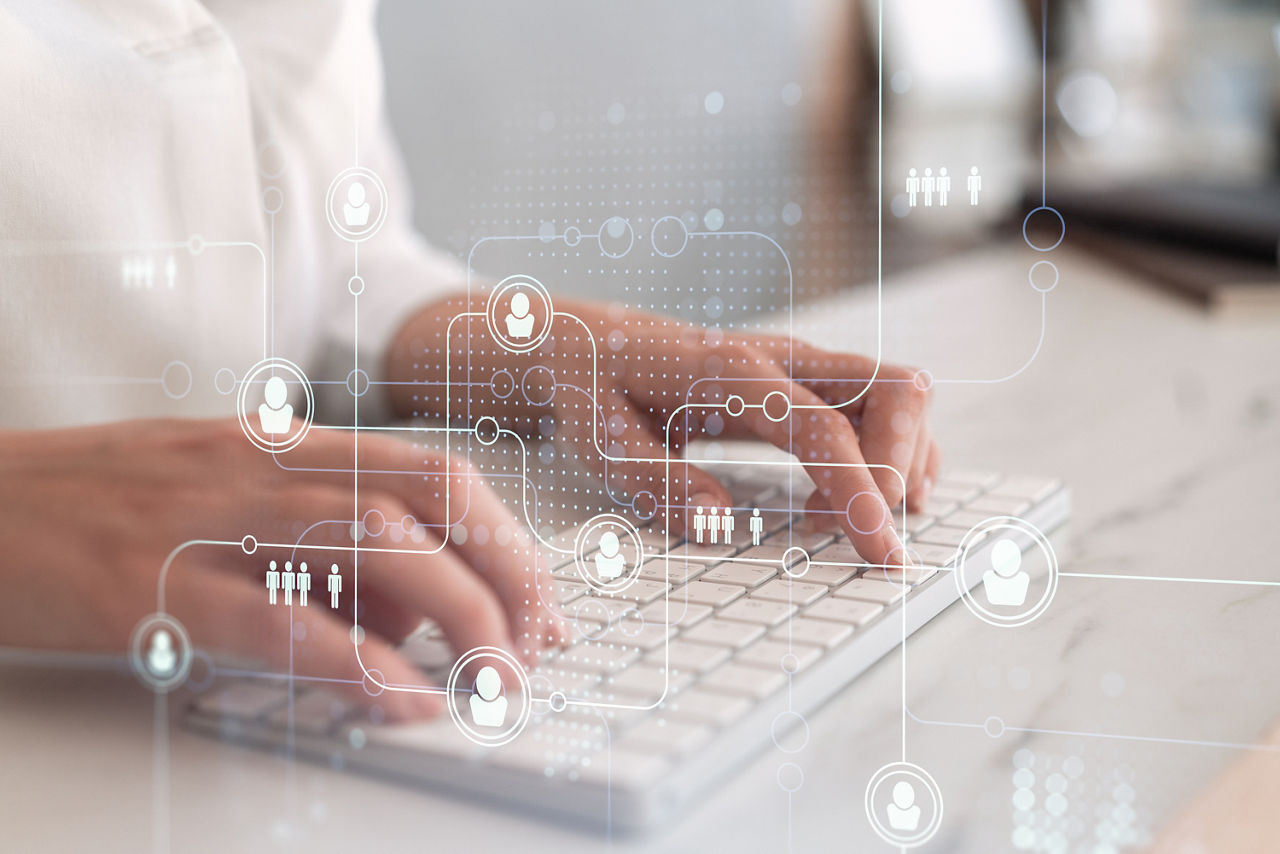 A digital representation of a person managing identity governance on a laptop, emphasizing automated processes to streamline compliance, Security | DXC Technology Capabilities