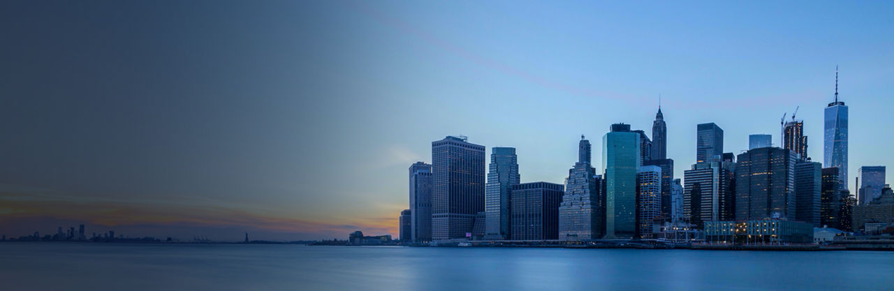 Westward view of Lower Manhattan at dusk, Reinsurance Solutions | DXC Technology