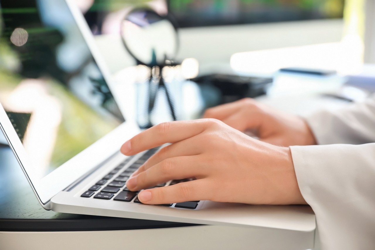 Female programmer working on laptop in office