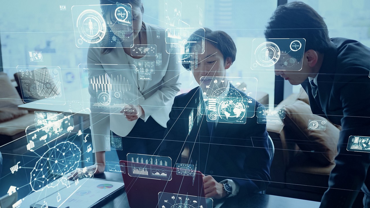 Team working in a meeting room in a blue glass building, Fast RISE with SAP | DXC Technology