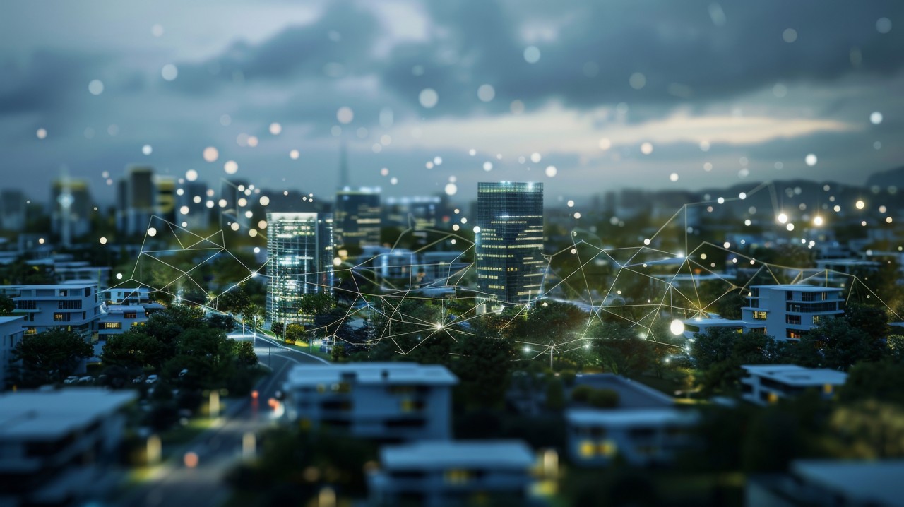 Aerial view of a city at night, with network of connections in the sky | DXC Technology