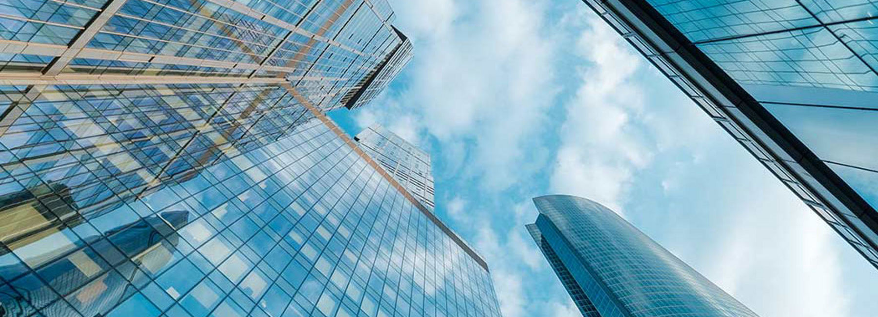 looking up at tall buildings, blue background, AWS | DXC Technology  