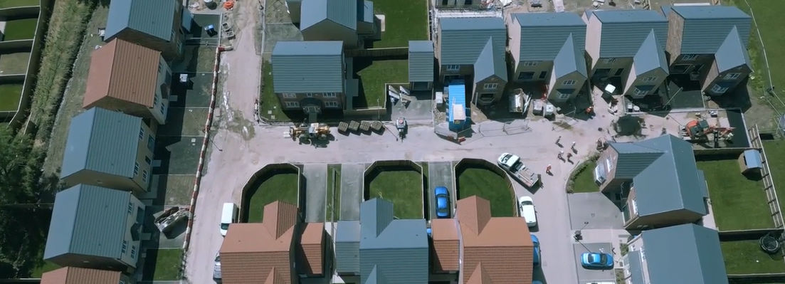 Aerial view of residential neighborhood at dusk, Corvias Video | DXC Technology Customer Story