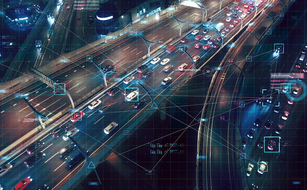 Aerial view of connected cars in traffic at night, Multinational automotive company, HPE | DXC Technology Customer Story