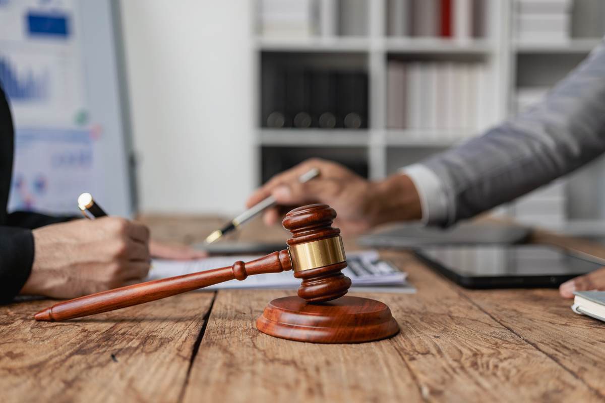 Gavel on table, Assure Legal Solutions | DXC Technology